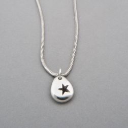 Silver pebble star necklace